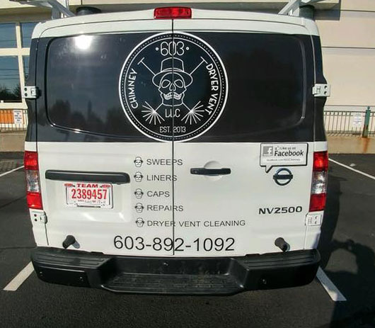 back end of white truck with 603 Chimney Dryer Vent logo in back windows